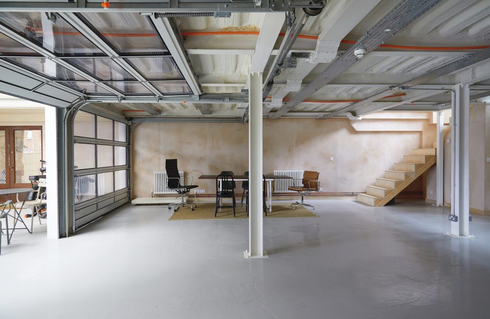 Ground floor garage space & sectional doors w: staircase to 1st floor studio