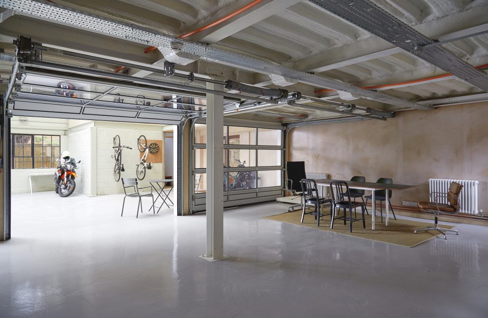 Ground floor garage space with sectional doors to courtyard