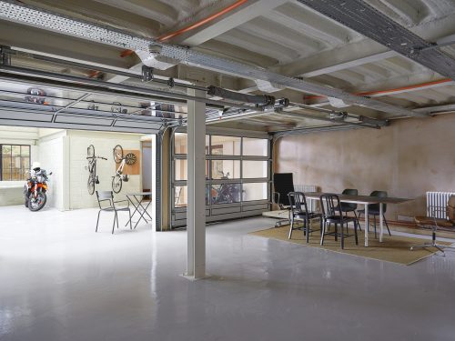 Ground floor garage space with sectional doors to courtyard