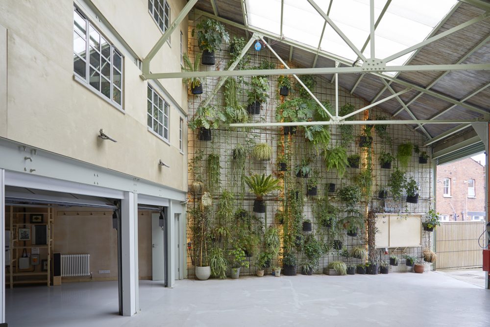 Triple height courtyard, living wall & rollor shutter entrance